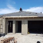 Front image of manufacturing of roof tiling for housing.