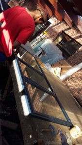 An employee working on the production of steel framing.