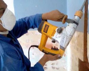 Contractor drilling into the Wall