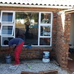 One of our team worker's measuring and manufacturing aluminium windows.