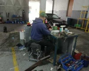 A man sitting and working in a workshop.
